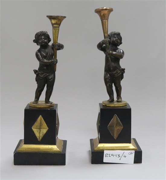 A pair of French bronze and gilt metal candlesticks